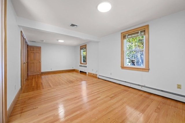 191 Speen, Natick, MA 01760 - empty room with a baseboard radiator, light wood-style floors, and baseboards
