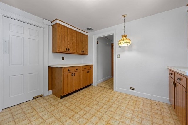 191 Speen, Natick, MA 01760 - kitchen featuring light floors, light countertops, brown cabinetry, and baseboards