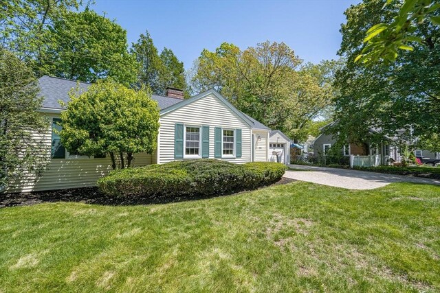 191 Speen, Natick, MA 01760 - view of property exterior with a chimney, a lawn, a garage, and driveway