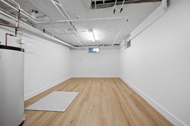 191 Speen, Natick, MA 01760 - basement with gas water heater, wood finished floors, and baseboards