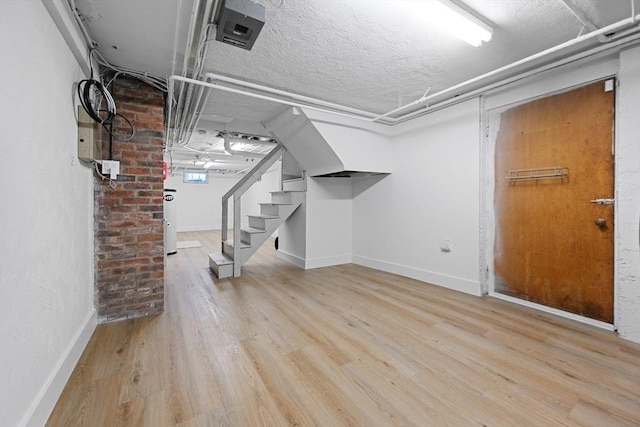 191 Speen, Natick, MA 01760 - finished basement featuring wood finished floors, stairway, baseboards, and a textured ceiling