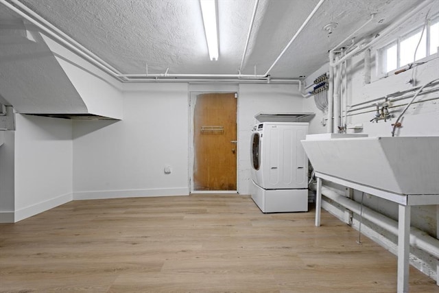 191 Speen, Natick, MA 01760 - clothes washing area featuring baseboards, light wood-type flooring, separate washer and dryer, and a textured ceiling