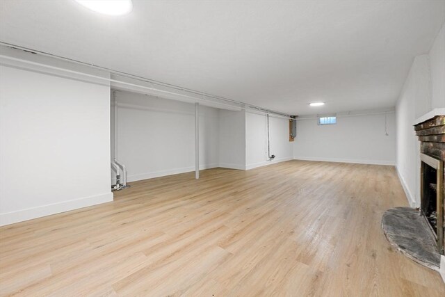 191 Speen, Natick, MA 01760 - basement with a fireplace, light wood-style floors, and baseboards