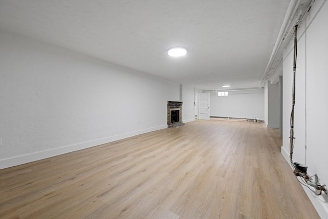 191 Speen, Natick, MA 01760 - unfurnished living room featuring a brick fireplace, light wood-type flooring, and baseboards