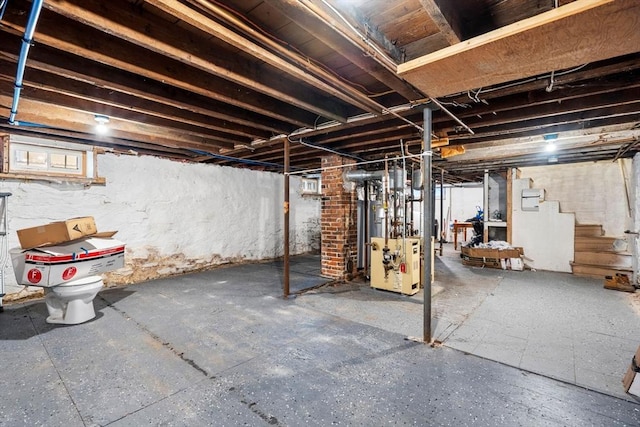 unfinished basement featuring stairway and a heating unit