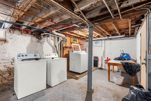 unfinished below grade area with washer and clothes dryer