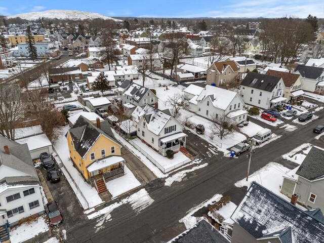 snowy aerial view featuring a residential view