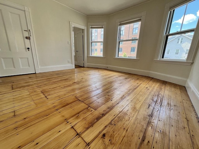 98 Boylston St Unit 1, Brookline, MA 02445 - empty room with baseboards, light wood-style flooring, and crown molding