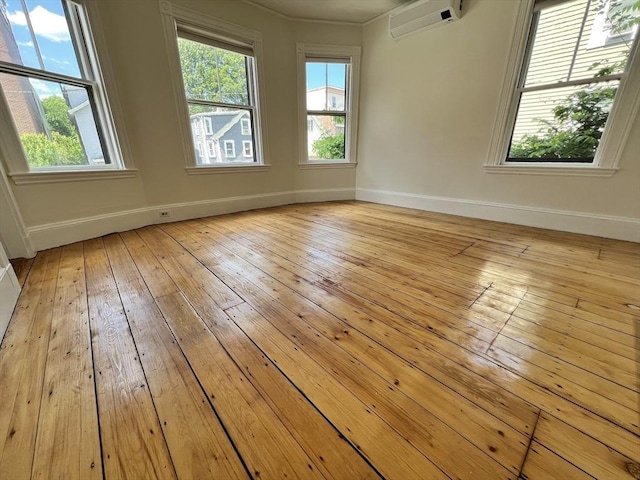 98 Boylston St Unit 1, Brookline, MA 02445 - unfurnished room with a wall mounted AC, baseboards, and plenty of natural light