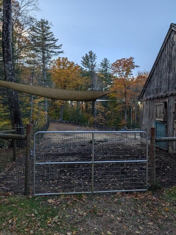 view of gate with an outbuilding