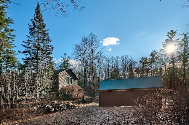 view of property exterior with an outbuilding