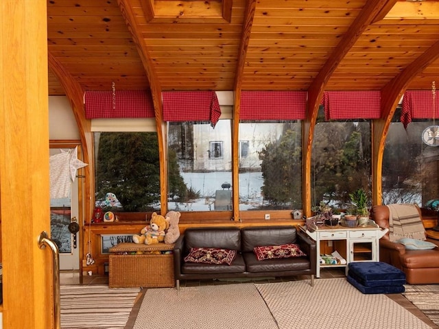 sunroom featuring beamed ceiling and wood ceiling