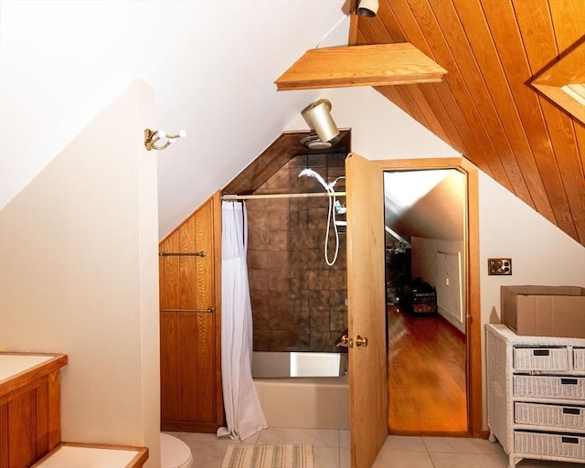 bonus room featuring vaulted ceiling and light tile patterned flooring