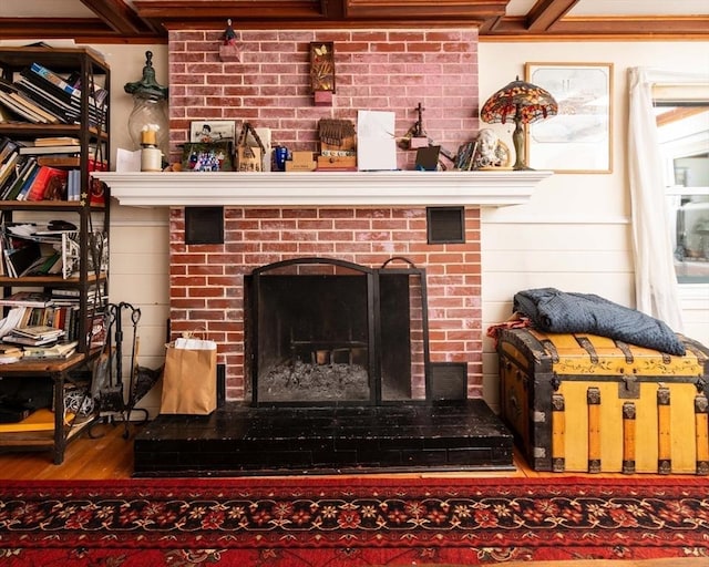 details featuring a brick fireplace and wood finished floors