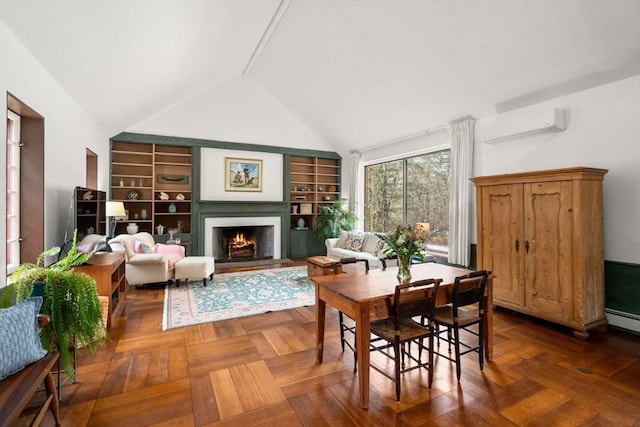 dining space featuring built in shelves, lofted ceiling, a warm lit fireplace, and a wall mounted AC