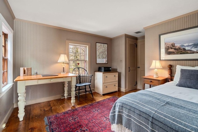 bedroom featuring wallpapered walls, visible vents, and hardwood / wood-style floors