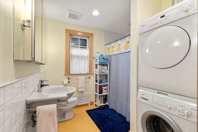 24 Aspen Ave, Newton, MA 02466 - washroom featuring stacked washer / drying machine, light tile patterned floors, and recessed lighting