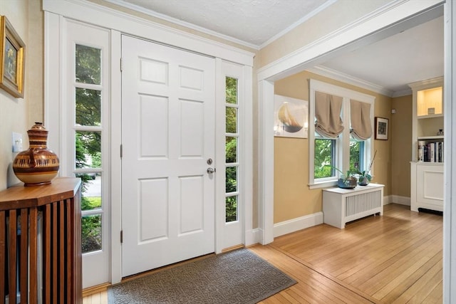 24 Aspen Ave, Newton, MA 02466 - foyer featuring light wood-style floors, ornamental molding, and radiator heating unit