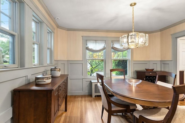 24 Aspen Ave, Newton, MA 02466 - dining space with a decorative wall, light wood-style floors, a chandelier, a wainscoted wall, and ornamental molding