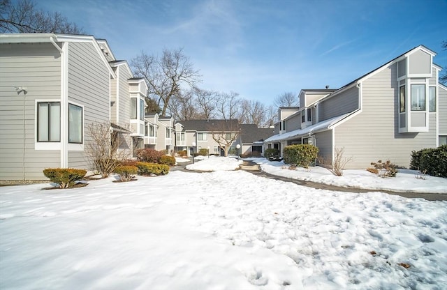 yard covered in snow featuring a residential view