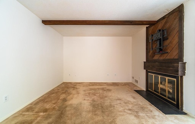 unfurnished living room featuring a textured ceiling, a large fireplace, visible vents, beam ceiling, and carpet