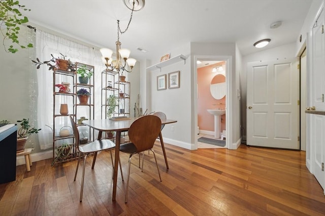 239 Prospect St Unit 2, Cambridge, MA 02139 - dining area featuring light wood finished floors, a chandelier, and baseboards