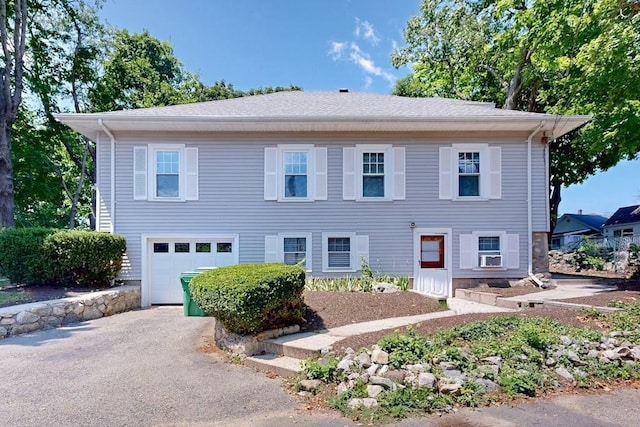 view of front of house featuring aphalt driveway and a garage