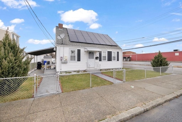 bungalow-style house with a front yard and solar panels