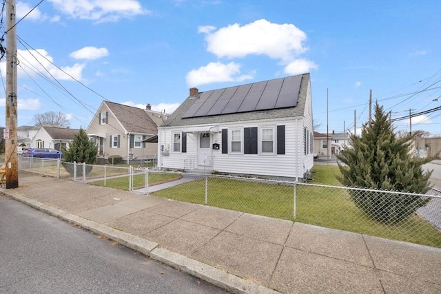 view of front of house featuring a front lawn and solar panels