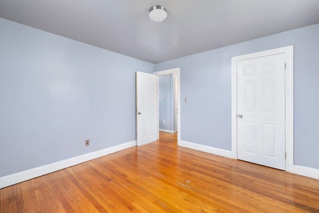 spare room featuring wood-type flooring