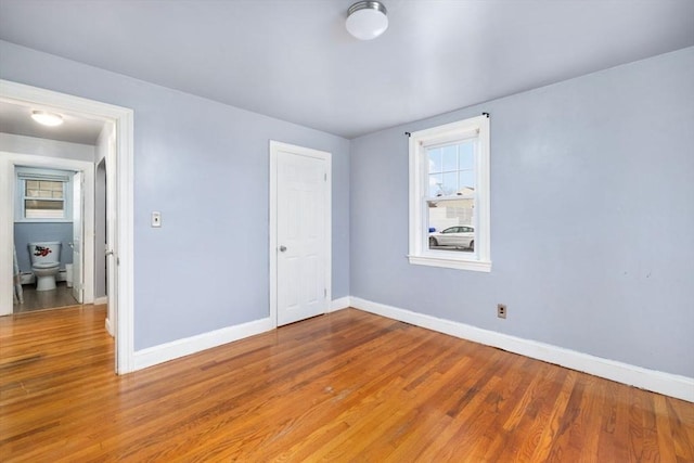 unfurnished room with wood-type flooring