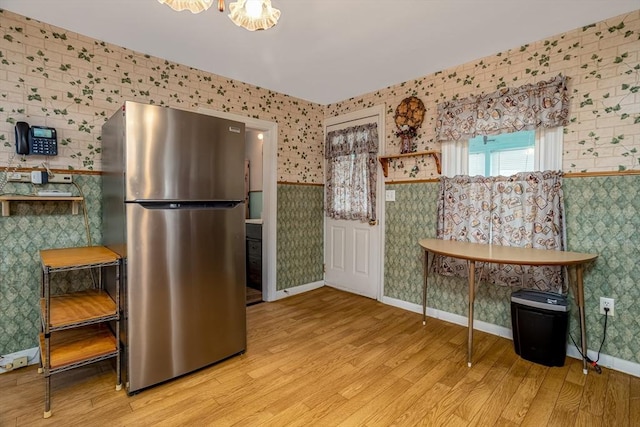 119 Clark St, Clinton, MA 01510 - kitchen featuring freestanding refrigerator, wallpapered walls, wood finished floors, a wainscoted wall, and baseboards
