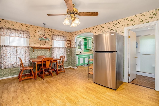 119 Clark St, Clinton, MA 01510 - dining space featuring wallpapered walls, a ceiling fan, light wood-style floors, healthy amount of natural light, and baseboards