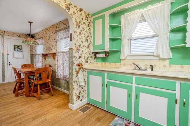 119 Clark St, Clinton, MA 01510 - kitchen with wallpapered walls, open shelves, light wood-style flooring, a sink, and baseboards