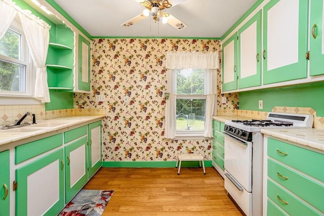 119 Clark St, Clinton, MA 01510 - kitchen featuring white range with gas cooktop, light wood-type flooring, a sink, wallpapered walls, and open shelves