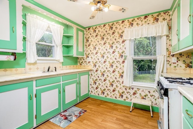 119 Clark St, Clinton, MA 01510 - kitchen with white gas range oven, light wood-style floors, a sink, baseboards, and healthy amount of natural light