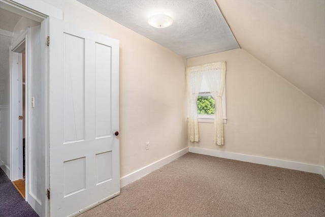 119 Clark St, Clinton, MA 01510 - bonus room featuring vaulted ceiling, carpet, a textured ceiling, and baseboards