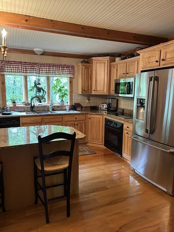 210 Wales Rd, Monson, MA 01057 - kitchen with black appliances, a sink, beam ceiling, backsplash, and light wood-style floors