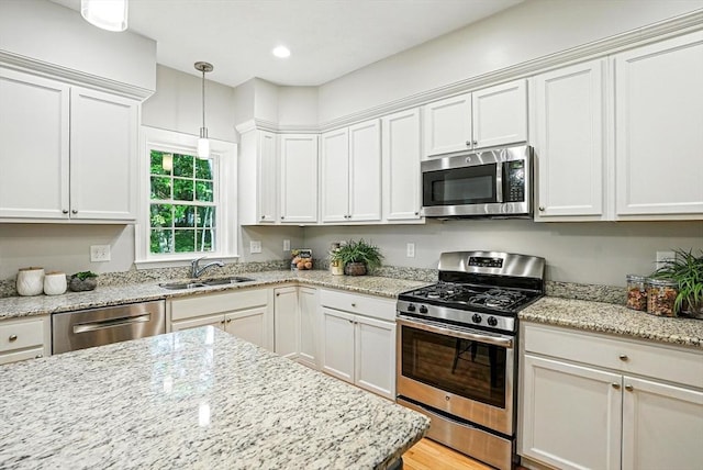 83 Partridge Hill Rd, Sutton, MA 01590 - kitchen with stainless steel appliances, white cabinetry, hanging light fixtures, light stone counters, and recessed lighting