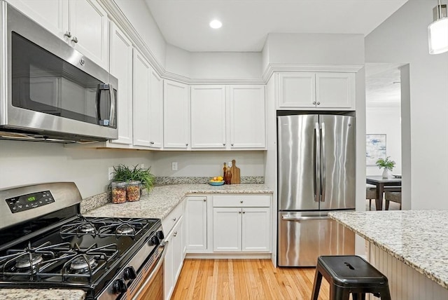 83 Partridge Hill Rd, Sutton, MA 01590 - kitchen with stainless steel appliances, white cabinets, light wood-style flooring, light stone counters, and recessed lighting