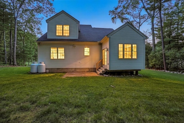 83 Partridge Hill Rd, Sutton, MA 01590 - back of house at dusk featuring entry steps, a lawn, and roof with shingles