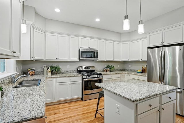 83 Partridge Hill Rd, Sutton, MA 01590 - kitchen with appliances with stainless steel finishes, light wood-style floors, white cabinets, a kitchen island, and recessed lighting