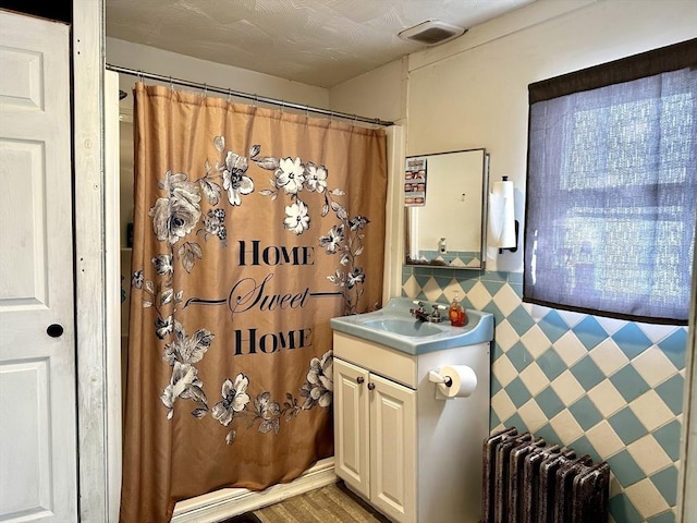 bathroom featuring vanity and radiator heating unit