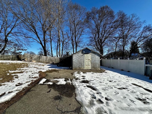 snowy yard with a storage unit