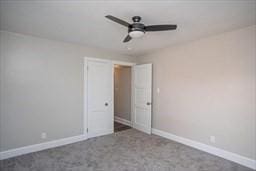 empty room with carpet flooring and ceiling fan