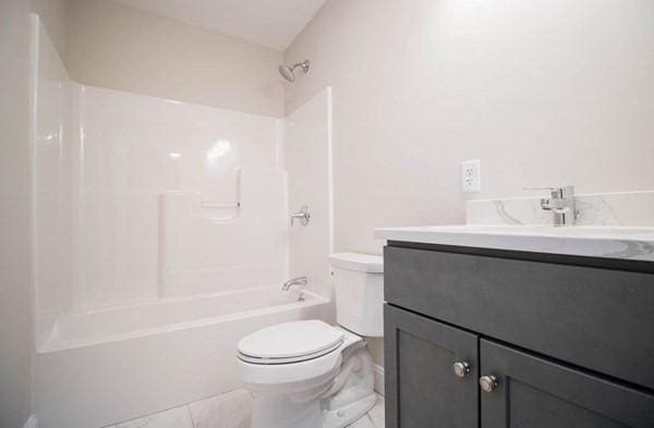 full bathroom featuring shower / tub combination, vanity, and toilet