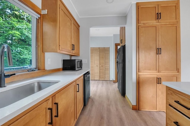 484 Rollstone St, Fitchburg, MA 01420 - kitchen with black appliances, light wood-style floors, plenty of natural light, light countertops, and crown molding