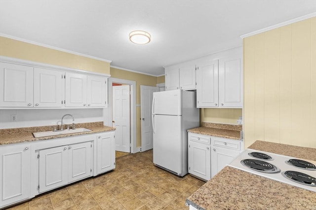 kitchen with sink, white cabinets, white refrigerator, ornamental molding, and cooktop