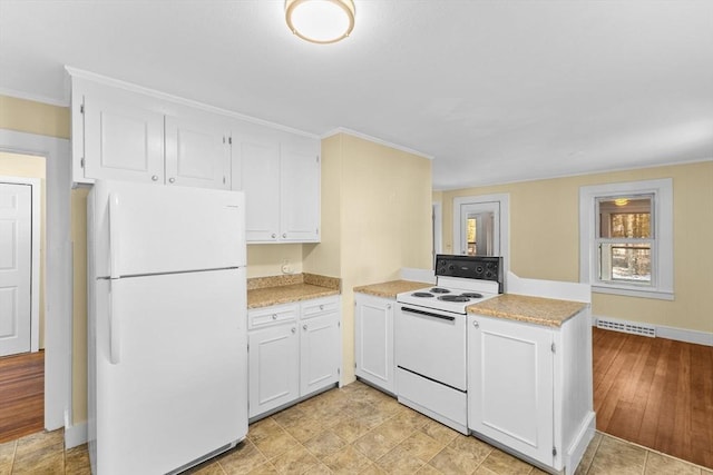 kitchen featuring white cabinetry, white appliances, and kitchen peninsula