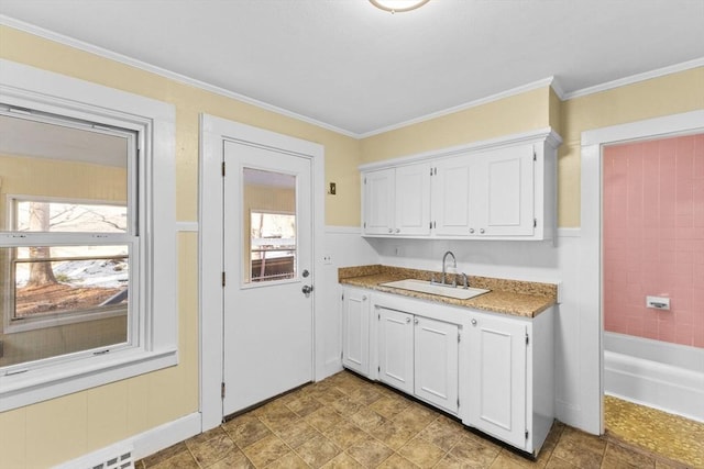 kitchen featuring plenty of natural light, sink, and white cabinets